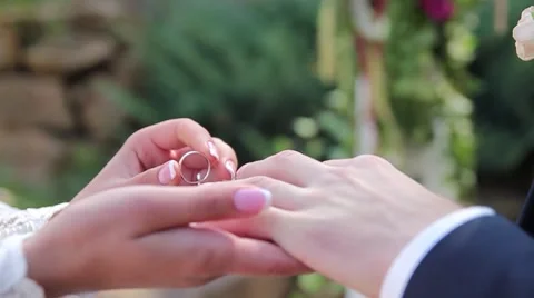 Groom puts on the ring on the finger of the bride Stock Footage 59834599