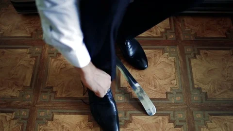 The groom puts on shoes Stock Footage 84776715