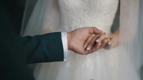 The groom puts the wedding ring on finger of the bride. marriage hands with 스톡 동영상 99481734
