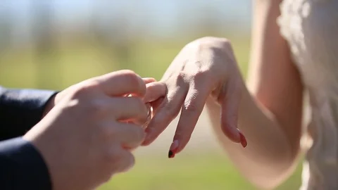 The groom puts the wedding ring on finger of the bride. Just married. The bride  스톡 동영상 103197580