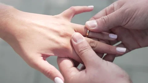 The Groom Puts The Wedding Ring On Finger Of The Bride Stock Footage 230120343