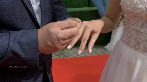 Groom Putting Wedding Ring on Bride Finger Stock Footage 337372607