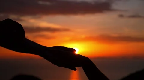 Groom putting a wedding ring on bride's finger, sunset Video stock 41880873
