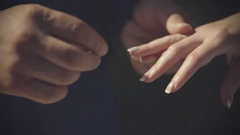 Groom putting a wedding ring on bride's finger Video stock 76809990