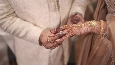 Groom putting wedding ring on brides finger close up shots 動画素材 325062789