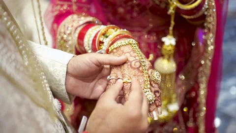 Groom Putting Wedding Ring on Bride's Hand Stock Footage 341874095