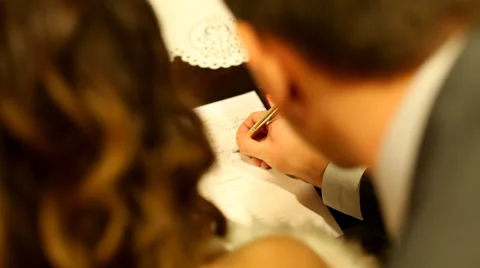 Groom signing wedding document Stock Footage 37246229