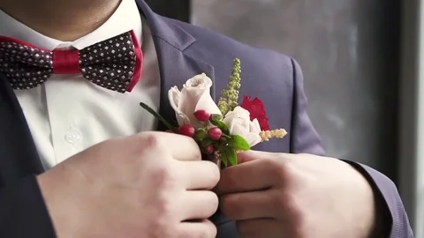 The groom straightens the buttonhole, wedding Video stock 82970997