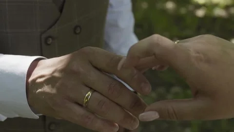 The groom strokes the hand of the bride with a ring on her hand Video stock 306147771