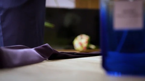 The groom takes a tie from the table Stock Footage 90127792
