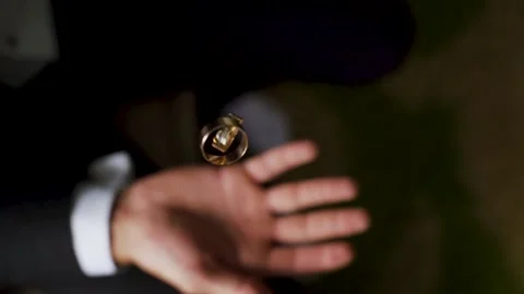 Groom throws up and holding wedding rings close up. Wedding details. Slow motion Stock Footage 205035419