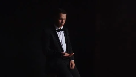 Groom throws up and holding wedding rings close up several times. Slow motion Stock Footage 242427386