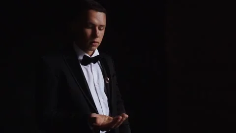 Groom throws up and holding wedding rings close up several times. Slow motion Stock Footage 243315974