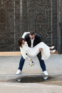 Groom throws bride in a puddle Stock Photos