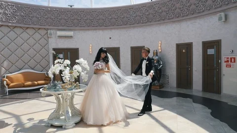 The groom throws up the veil of the bride Stock Footage 106349888
