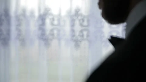Groom uses perfume on light background. Stock-Footage 89134435