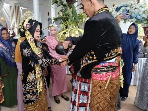 The groom is wearing traditional Javanese Stock Photos