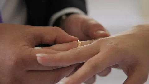 The groom wears a ring to the bride Stock Footage 87945760