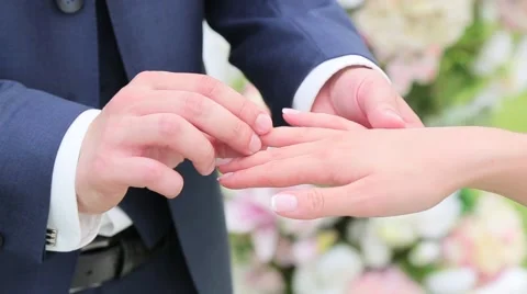 Groom wears ring on the bride's finger Stock Footage 64862257