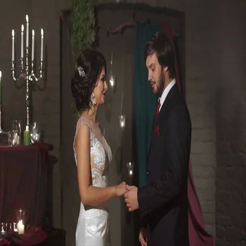 The groom wears a wedding ring a bride in a fabulous location with candles Video stock 69407061