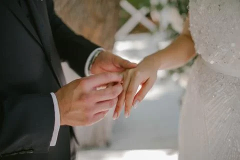 The groom wears a wedding ring to the bride Stock Photos