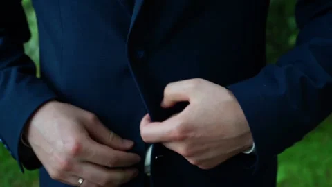 The groom zips up his jacket Stock Footage 163566622