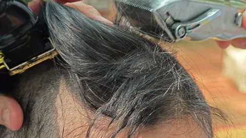 Grooming moment, shaves head using an electric trimmer. Stock Footage 306994012