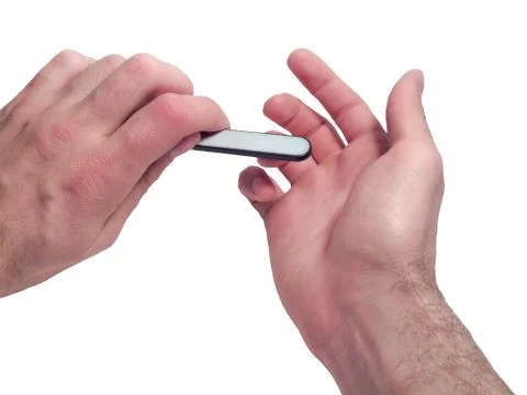 Grooming of nails on a man's hand Stock Photos