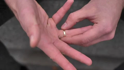 The groom's hand spins the ring on his finger Stock-Footage 311456566