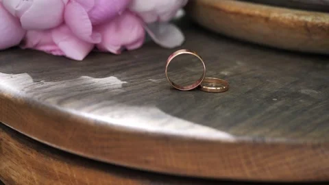 Groom's ring rolls to bride's ring. wedding rings, symbol of wedding celebration Stock Footage 312122788