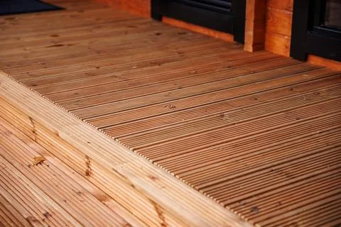 Grooved Timber Decking Step Leading To Dark Framed Cabin Doors Stock Photos