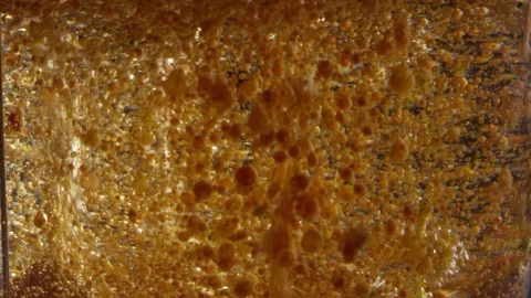 Gross oozing abstract bubbling orange and brown liquid texture background 스톡 동영상 118295348