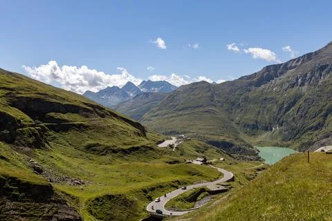 The Grossglockner mountain range in Austria with a winding road leading to .. Stock Photos