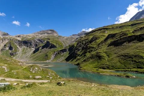 The Grossglockner mountain range in Austria with a winding road leading to .. Stock Photos