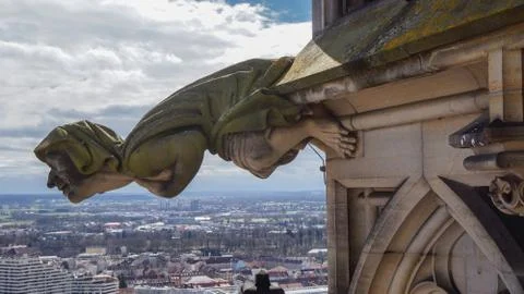 Grotesque gargoyle in gothic minster Stock Photos