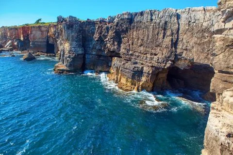 Grotto in the coastal cliffs Stock Photos
