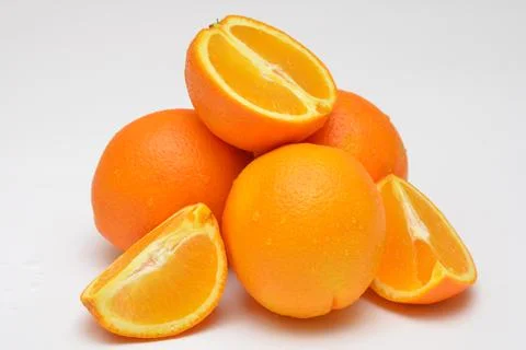 Grou p of objects whole and cut oranges on a white background Stock Photos