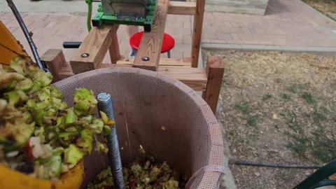Ground Apples Poured Into Press Machine in Slow Motion Today Stock Footage 346688528