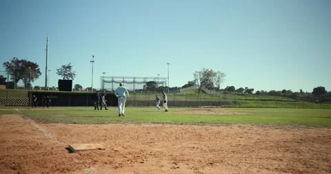 Ground ball to first prompting man fielding baseball, forcing runner out, batter Stock Footage 334922912