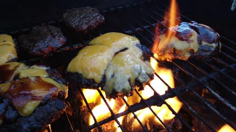 Ground beef burger patties grilling on a barbecue Stock Footage 157350687