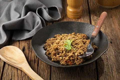Ground beef in dark plate on the table. Stock Photos