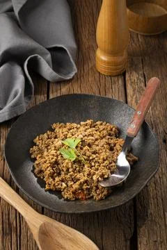 Ground beef in dark plate on the table. Stock Photos