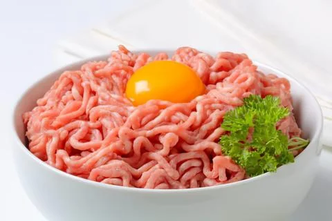Ground beef with egg and parsley in bowl Stock Photos