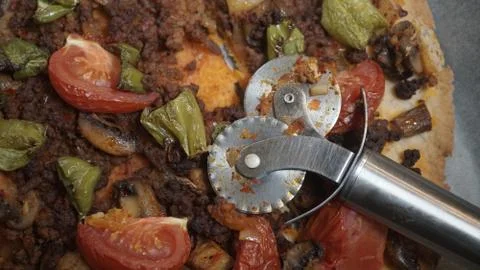 Ground beef pizza with a knife. Stock Photos