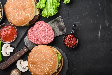 Ground beef steaks for home made burger on black background, top view with co Stock Photos
