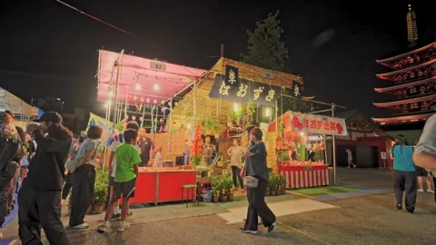 Ground Cherry Market Stall at Night Festival with Distant Pagoda, Tokyo 動画素材 342710280