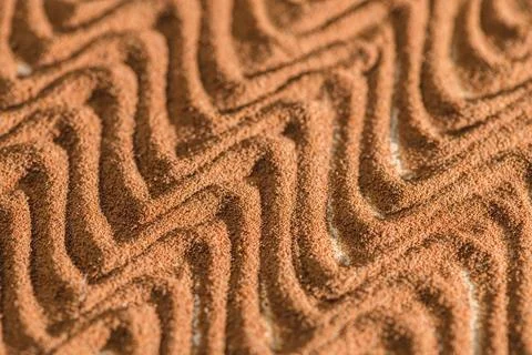 Ground chicory root forming a wavy pattern creates an intriguing texture, sho Stock Photos