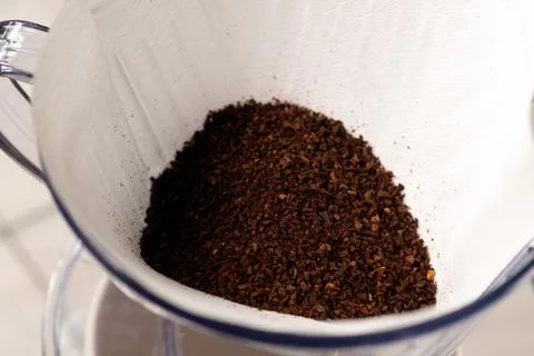 Ground coffee beans in a filter drip holder.  Stock Photos