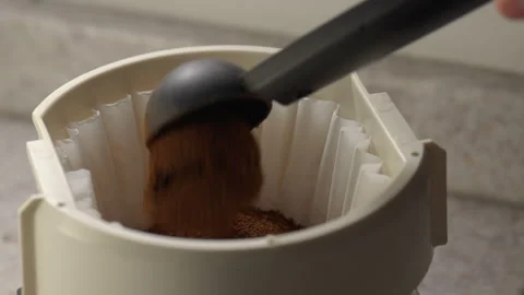 Ground coffee being poured into a coffee filter Stock Footage 311837115
