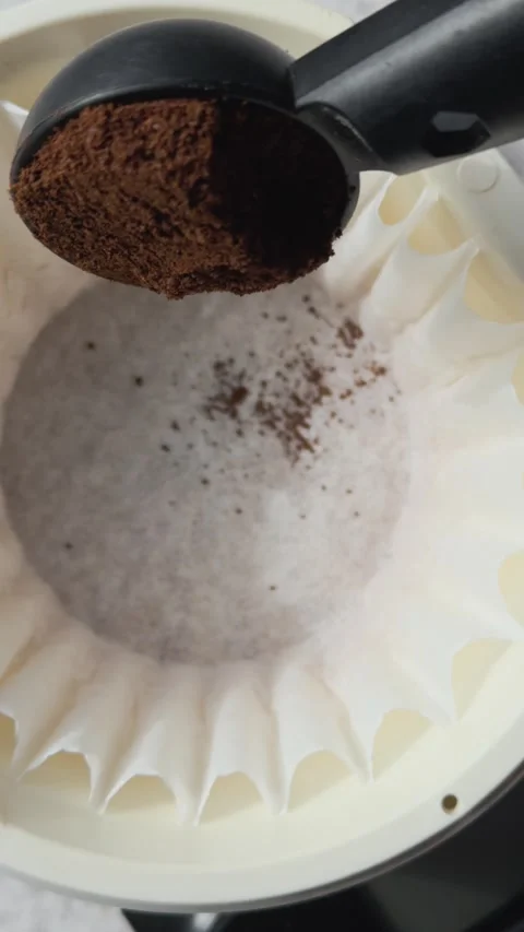 Ground Coffee Being Poured into Coffee Filter Stock Footage 314584141